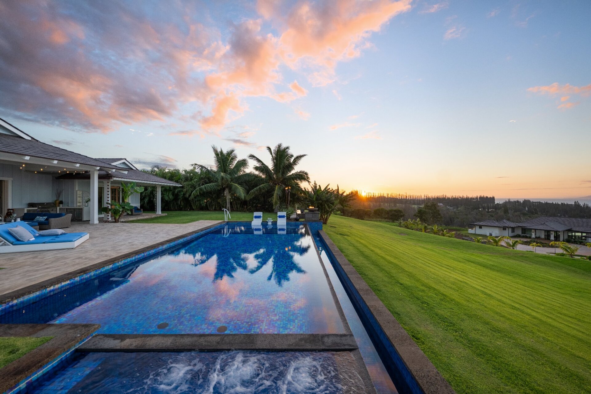 Infinity edge pool and spa at 300 Mahana Ridge reflecting clear blue sky with ocean horizon views Kapalua